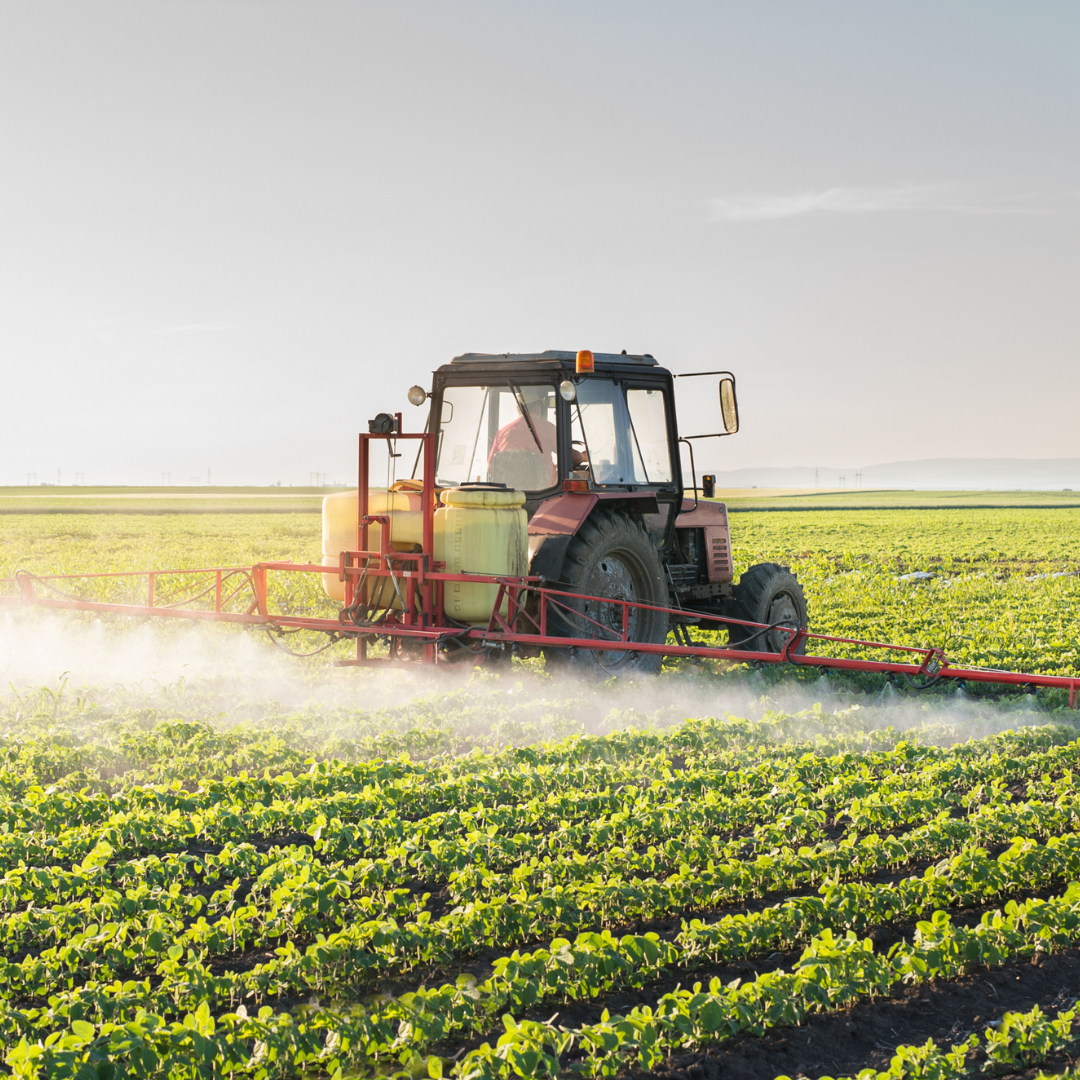 Farm tractor spraying field