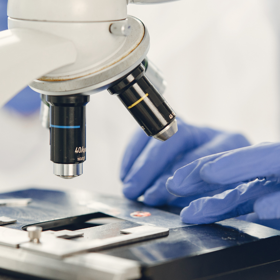 Close-up of Lab Worker Looking at Specimen under Microscope