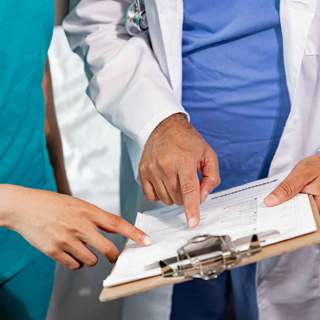Doctor and nurse checking medical report